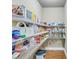 Walk-in pantry featuring custom shelving and ample storage space for all your essentials at 8240 Hurakan Creek Xing, Cumming, GA 30028