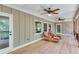 Cozy screened porch featuring rustic furniture, white wood ceilings, and tranquil views at 8240 Hurakan Creek Xing, Cumming, GA 30028