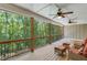 Relaxing screened-in porch with nature views, perfect for enjoying the outdoors in comfort at 8240 Hurakan Creek Xing, Cumming, GA 30028