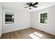 Bright bedroom featuring two windows and a modern ceiling fan at 1227 Kenilworth Dr, Atlanta, GA 30310