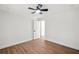 A bright bedroom with hardwood floors, a ceiling fan, and a view of a doorway at 1227 Kenilworth Dr, Atlanta, GA 30310