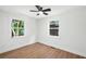 A bright bedroom with hardwood floors and double hung windows with green tree views at 1227 Kenilworth Dr, Atlanta, GA 30310