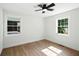 Bright bedroom with hardwood floors, modern ceiling fan, and white walls and trim at 1227 Kenilworth Dr, Atlanta, GA 30310