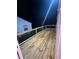 Newly installed wooden deck with a dark railing at dusk at 1227 Kenilworth Dr, Atlanta, GA 30310