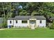 Charming home with fresh lawn, blue door and wood porch at 1227 Kenilworth Dr, Atlanta, GA 30310