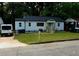 Charming home featuring a newly-mowed lawn, fresh paint, and a bright blue front door at 1227 Kenilworth Dr, Atlanta, GA 30310