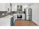 A modern kitchen featuring stainless steel appliances, white cabinets, and sleek countertops at 1227 Kenilworth Dr, Atlanta, GA 30310