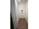 Narrow laundry room area featuring hookups, hardwood-style flooring, and a ceiling hatch at 1227 Kenilworth Dr, Atlanta, GA 30310