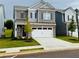 Charming two-story home with brick and gray siding, a two-car garage, and a well-manicured lawn at 2690 Ravencliff Dr, Austell, GA 30168