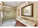 Well-lit bathroom features a shower, a toilet, and a vanity with a granite countertop at 8480 Valemont Dr, Sandy Springs, GA 30350
