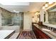 Spacious bathroom with a soaking tub, tiled shower, and long double vanity at 8480 Valemont Dr, Sandy Springs, GA 30350