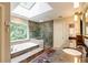 Sunlit bathroom featuring a soaking tub, glass shower, and granite double vanity at 8480 Valemont Dr, Sandy Springs, GA 30350