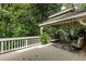 Relaxing covered deck featuring plush seating, an outdoor rug, and white railings at 8480 Valemont Dr, Sandy Springs, GA 30350