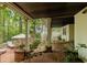 Relax on this covered patio area with brick floor and stone fireplace at 8480 Valemont Dr, Sandy Springs, GA 30350