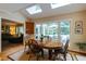 Bright dining area with large windows overlooking the outdoor deck and backyard at 8480 Valemont Dr, Sandy Springs, GA 30350