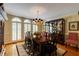 Formal dining room with hardwood floors, a large dining table, china cabinet, and bright windows at 8480 Valemont Dr, Sandy Springs, GA 30350