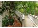 Spacious deck and stairs lead to outdoor patio surrounded by mature trees at 8480 Valemont Dr, Sandy Springs, GA 30350