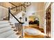 Grand foyer with a curved staircase, hardwood floors, and a view into the living room at 8480 Valemont Dr, Sandy Springs, GA 30350