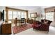 Well-lit home office with plush armchair, desk, vintage area rug, and large window at 8480 Valemont Dr, Sandy Springs, GA 30350