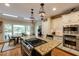 Bright kitchen with stainless steel appliances, granite countertops and a large island with a gas cooktop at 8480 Valemont Dr, Sandy Springs, GA 30350