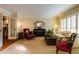 Bright living room with classic furnishings, plantation shutters, and hardwood floors at 8480 Valemont Dr, Sandy Springs, GA 30350