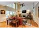 Inviting living room featuring high ceilings, a fireplace, and large windows with plantation shutters at 8480 Valemont Dr, Sandy Springs, GA 30350