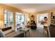 Cozy living room featuring neutral decor and a seamless flow to sunroom and dining area at 8480 Valemont Dr, Sandy Springs, GA 30350