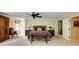 Spacious main bedroom with decorative furnishings, a ceiling fan, and neutral carpet at 8480 Valemont Dr, Sandy Springs, GA 30350