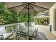 Outdoor deck with an umbrella table and a view of the landscaped backyard and gazebo at 8480 Valemont Dr, Sandy Springs, GA 30350