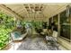 Cozy outdoor porch with seating, plants, overhead fan and beautiful views at 8480 Valemont Dr, Sandy Springs, GA 30350