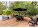 Brick patio offers space for dining and grilling, with an umbrella for shade at 8480 Valemont Dr, Sandy Springs, GA 30350