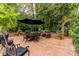 Secluded brick patio featuring outdoor seating and a black patio umbrella at 8480 Valemont Dr, Sandy Springs, GA 30350