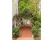 Landscaped brick walkway with overhead foliage leading to a charming home exterior at 8480 Valemont Dr, Sandy Springs, GA 30350