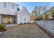 Expansive backyard featuring a patio, garden bed, and a charming stone wall, perfect for outdoor activities at 915 Laurel Brooke Ave, Peachtree City, GA 30269