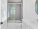 Modern bathroom featuring a glass-enclosed shower over tub and a sleek vanity with a white countertop at 915 Laurel Brooke Ave, Peachtree City, GA 30269