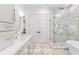 Luxurious bathroom with a glass shower, soaking tub, and double vanity with marble countertops at 915 Laurel Brooke Ave, Peachtree City, GA 30269