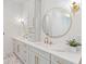 Bathroom featuring double sink vanity with marble countertops and round gold mirrors at 915 Laurel Brooke Ave, Peachtree City, GA 30269