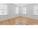 Bright bedroom offering three windows, wood floor, and minimalist design at 915 Laurel Brooke Ave, Peachtree City, GA 30269