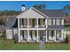 Charming two-story home showcasing a welcoming front porch with classic columns and a well-maintained lawn at 915 Laurel Brooke Ave, Peachtree City, GA 30269