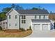 Rear exterior of the home featuring a three car garage and ample outdoor space at 915 Laurel Brooke Ave, Peachtree City, GA 30269