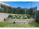 Beautifully landscaped garden area with vibrant flowers, a charming stone wall, and lush green grass at 915 Laurel Brooke Ave, Peachtree City, GA 30269