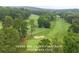 Aerial view of a lush golf course showcasing the picturesque landscape of Peachtree City at 915 Laurel Brooke Ave, Peachtree City, GA 30269