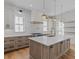 Well-appointed kitchen featuring quartz countertops, island with seating, and designer fixtures at 915 Laurel Brooke Ave, Peachtree City, GA 30269