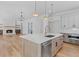 Modern kitchen with an island, stainless appliances, and hardwood floors at 915 Laurel Brooke Ave, Peachtree City, GA 30269
