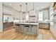 Gourmet kitchen with stainless steel appliances, a large center island, and stylish pendant lighting at 915 Laurel Brooke Ave, Peachtree City, GA 30269