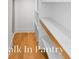 Spacious walk-in pantry featuring custom shelving and wood accents at 915 Laurel Brooke Ave, Peachtree City, GA 30269