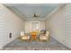 Cozy covered patio with comfortable seating, ideal for outdoor relaxation and entertaining guests at 915 Laurel Brooke Ave, Peachtree City, GA 30269