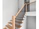 Bright staircase featuring wood treads and black metal railings, complementing the home's modern design at 915 Laurel Brooke Ave, Peachtree City, GA 30269
