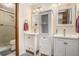 Bathroom featuring dual sink vanities with white cabinets and a glass enclosed shower at 95 Oak Grove Cir, Mcdonough, GA 30253