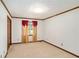 Neutral carpeted bedroom featuring closet with wood trim doors, window with curtains and natural light at 95 Oak Grove Cir, Mcdonough, GA 30253